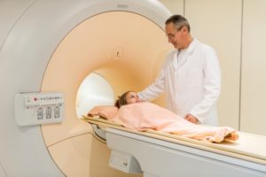 Smiling Radiologist Talking To Little Girl Before Mri Scan.